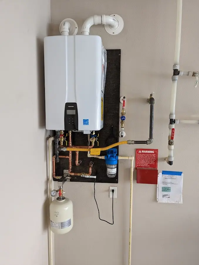 Professional plumber installing copper piping in a University Park home